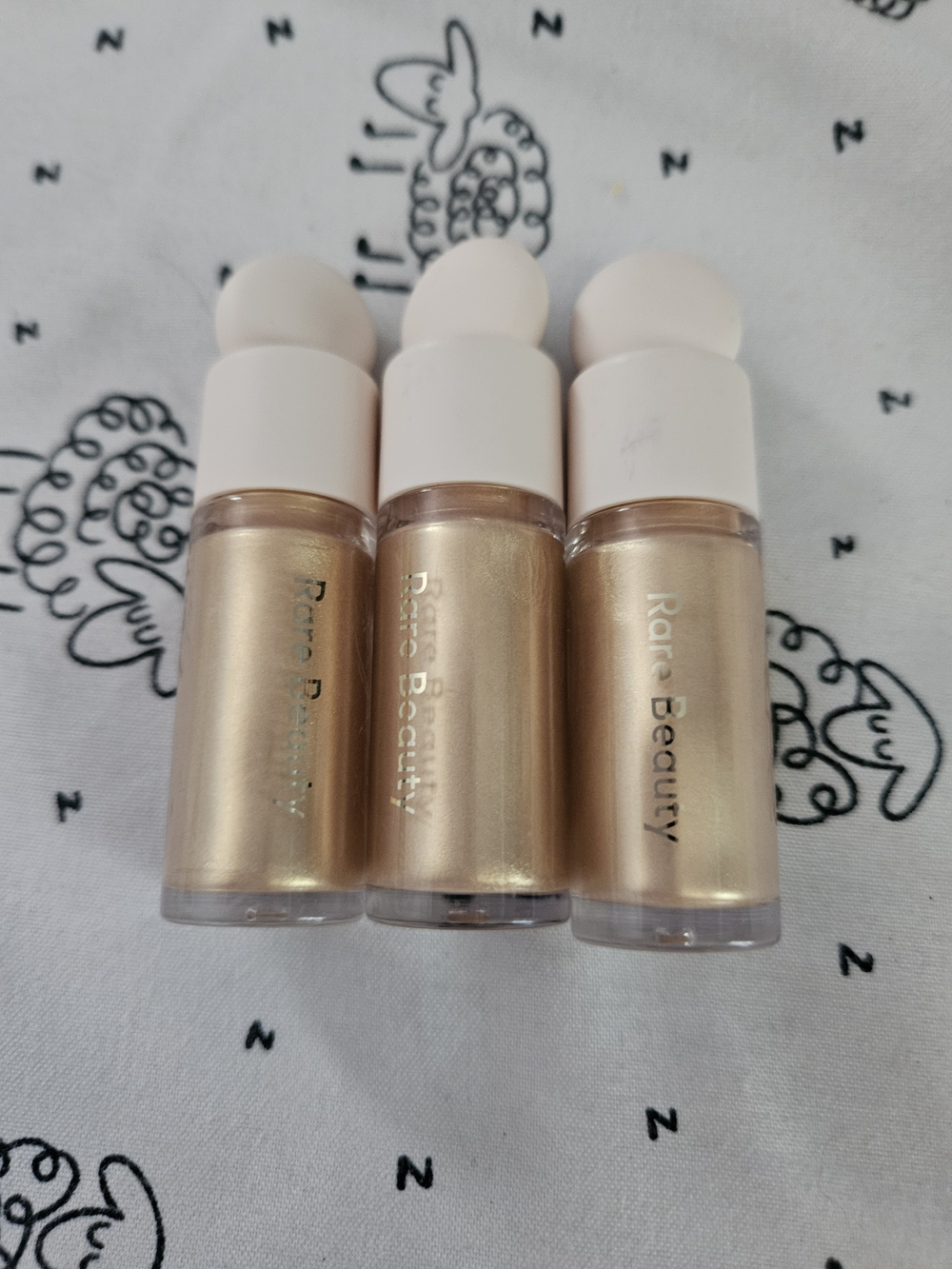 3 x Outshine Rare Beauty Liquid Highlighter Trio — Champagne, Gold